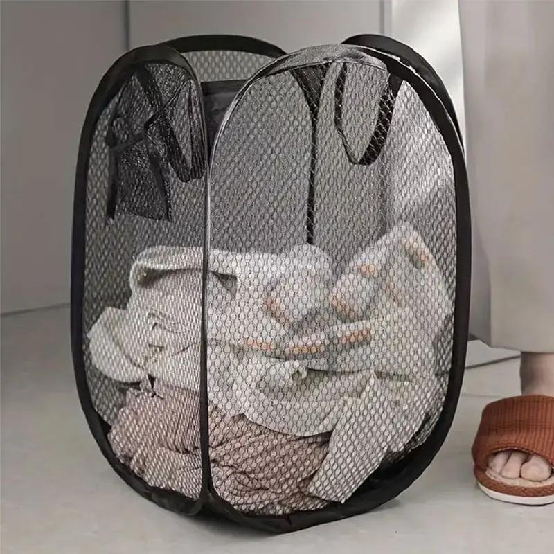 Black mesh pop-up laundry basket in a bathroom